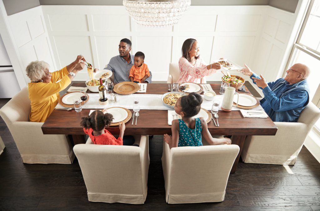 Family enjoying food in dining room | JR Floors and Window Coverings